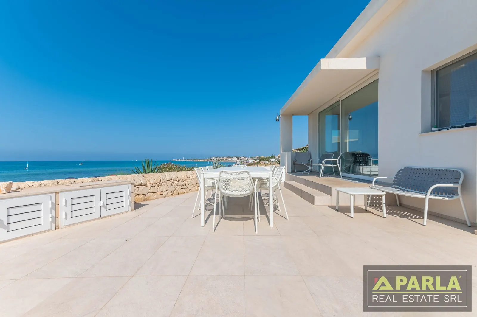 Seafront terrace with dining table